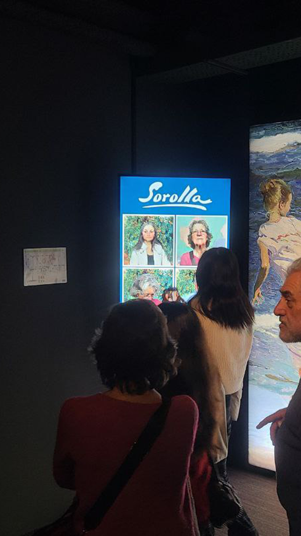 Screen with portraits of the audience