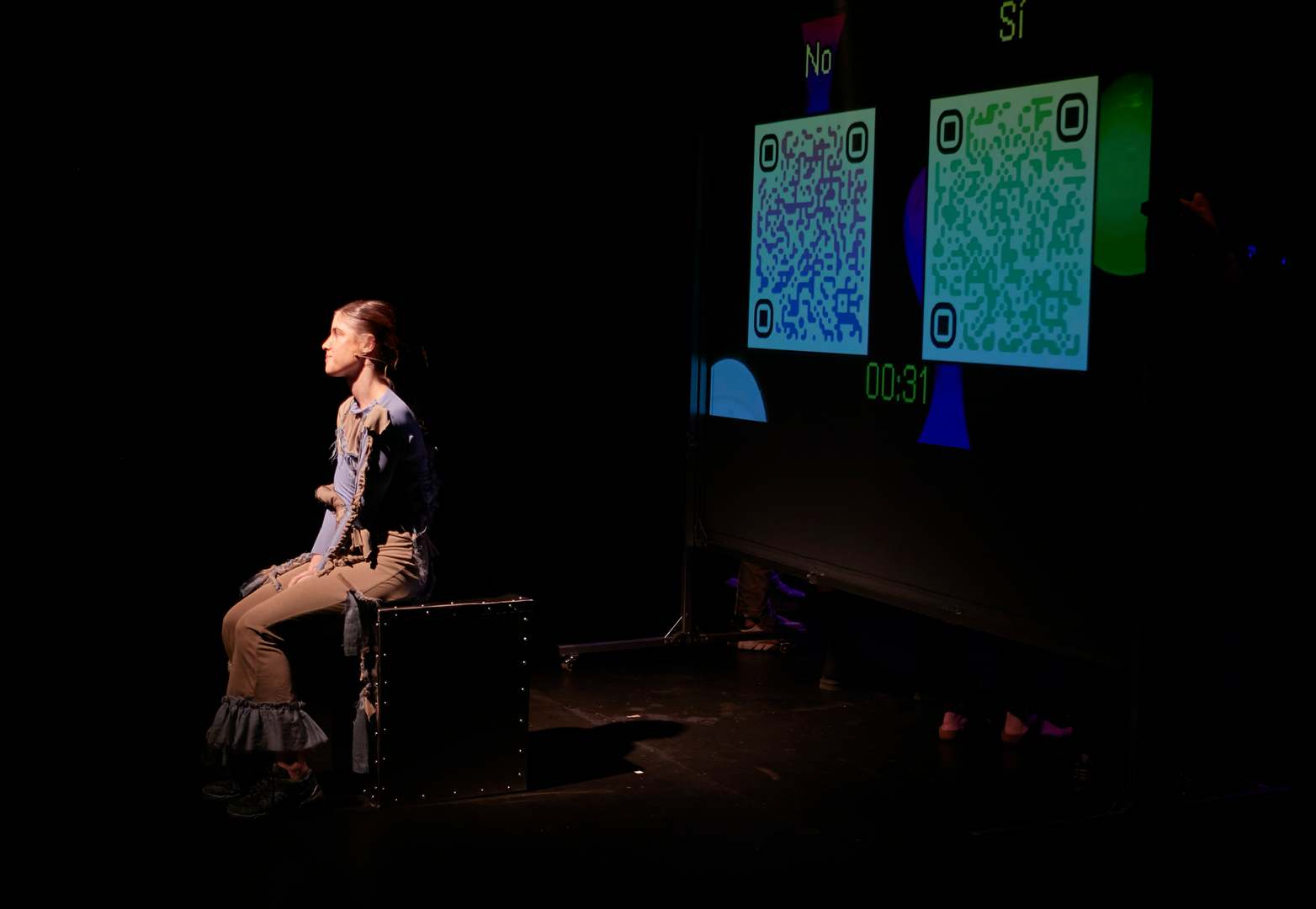 Performer in front of QR codes for audience interaction